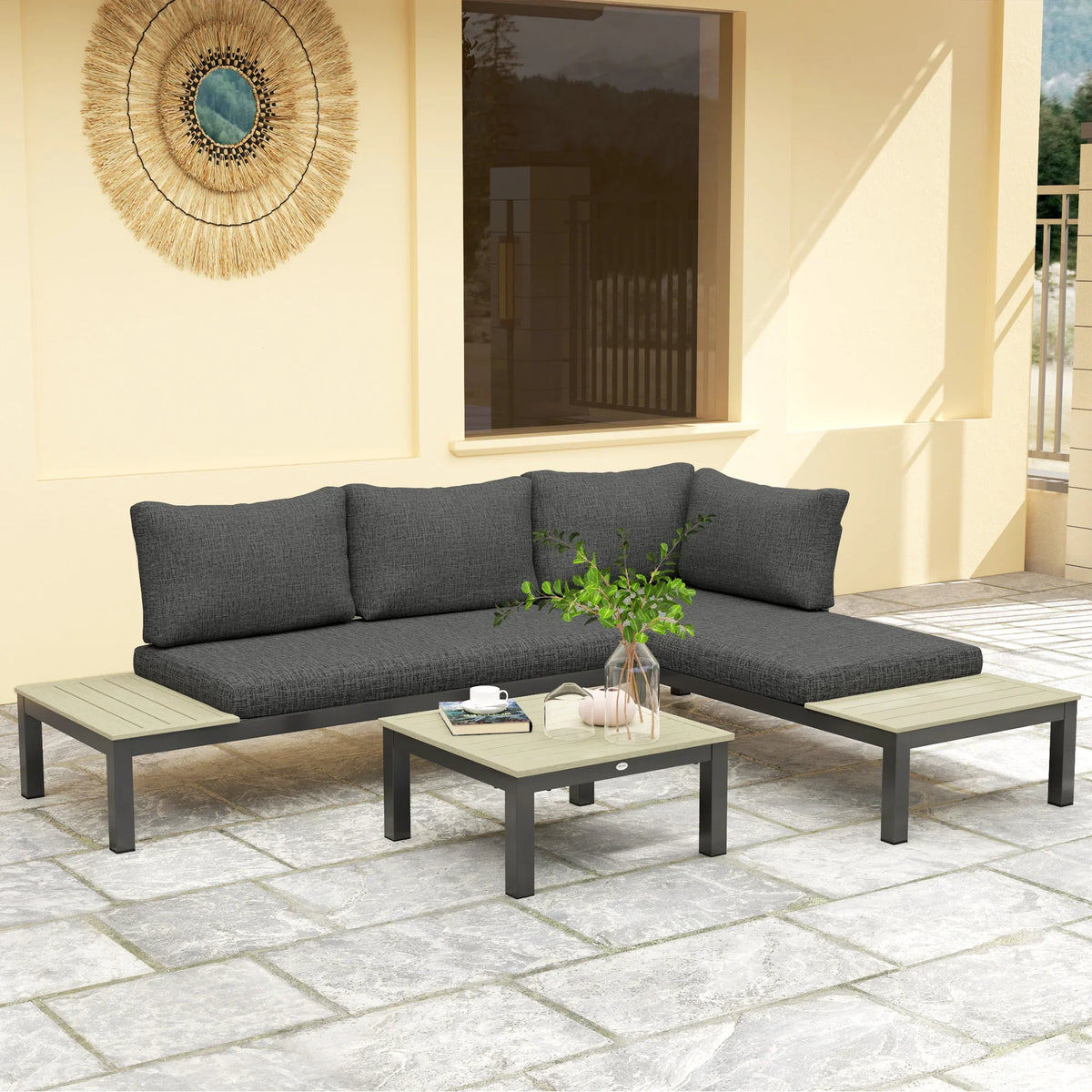 Dark gray outdoor corner sofa with four back cushions and matching square coffee table on patio