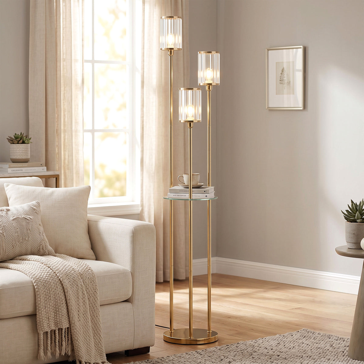 Gold three-light floor lamp with glass shelf and three crystal-like glass shades
