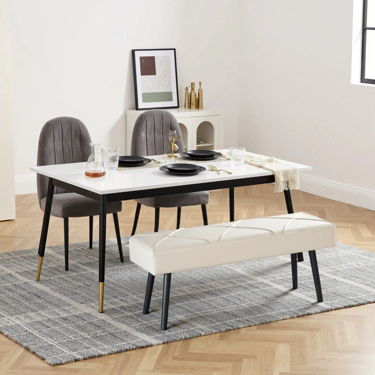 Cream upholstered bench with X-stitch front and black legs