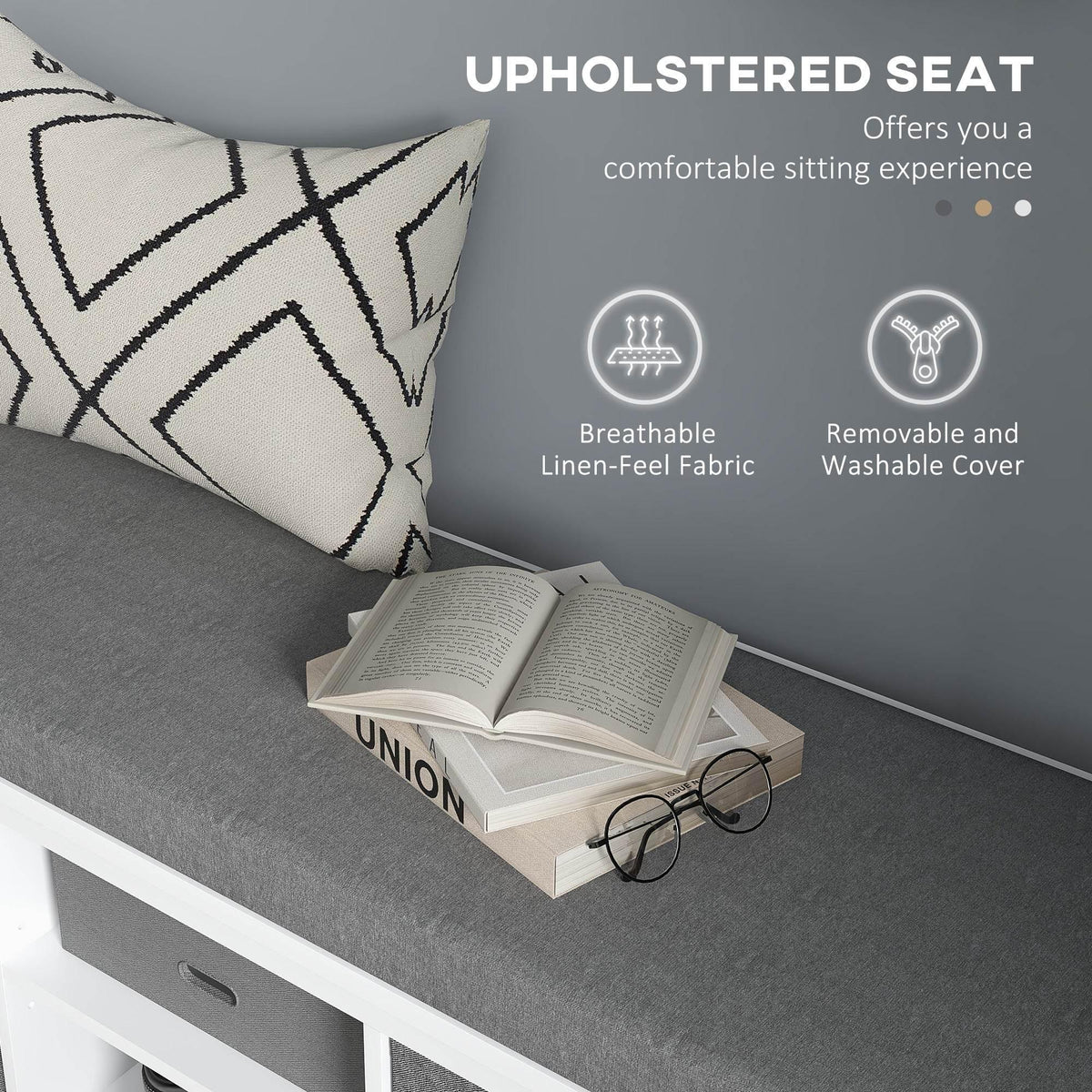 Shoe storage bench seat with removable cover, gray upholstery, pillow and book on top
