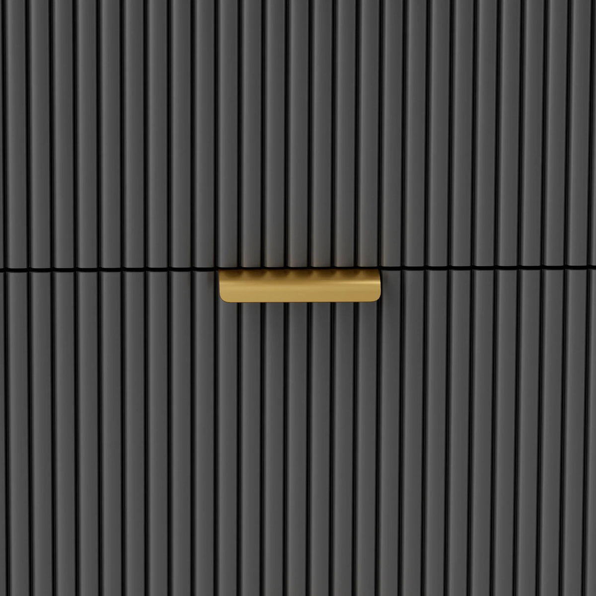 Close-up of a gold bar drawer handle on a black ridged front