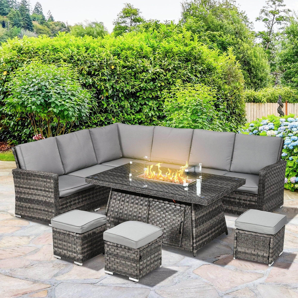 Gray rattan garden furniture set with L-shaped sofa, fire pit table, and ottoman stools