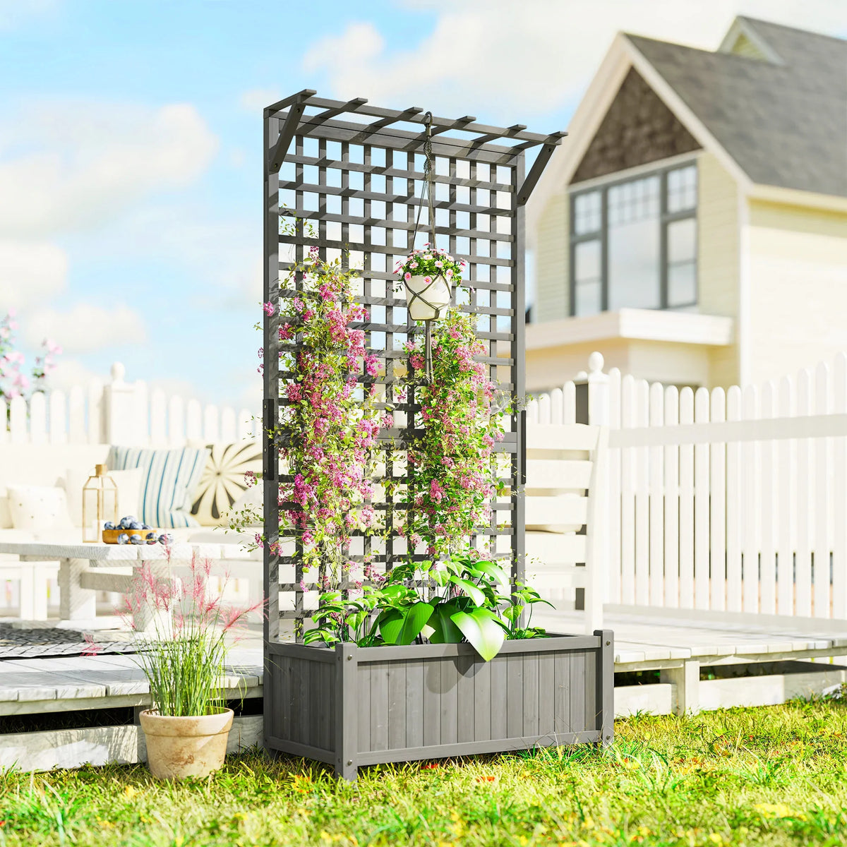 Dark grey raised planter box with trellis for climbing plants and flower baskets