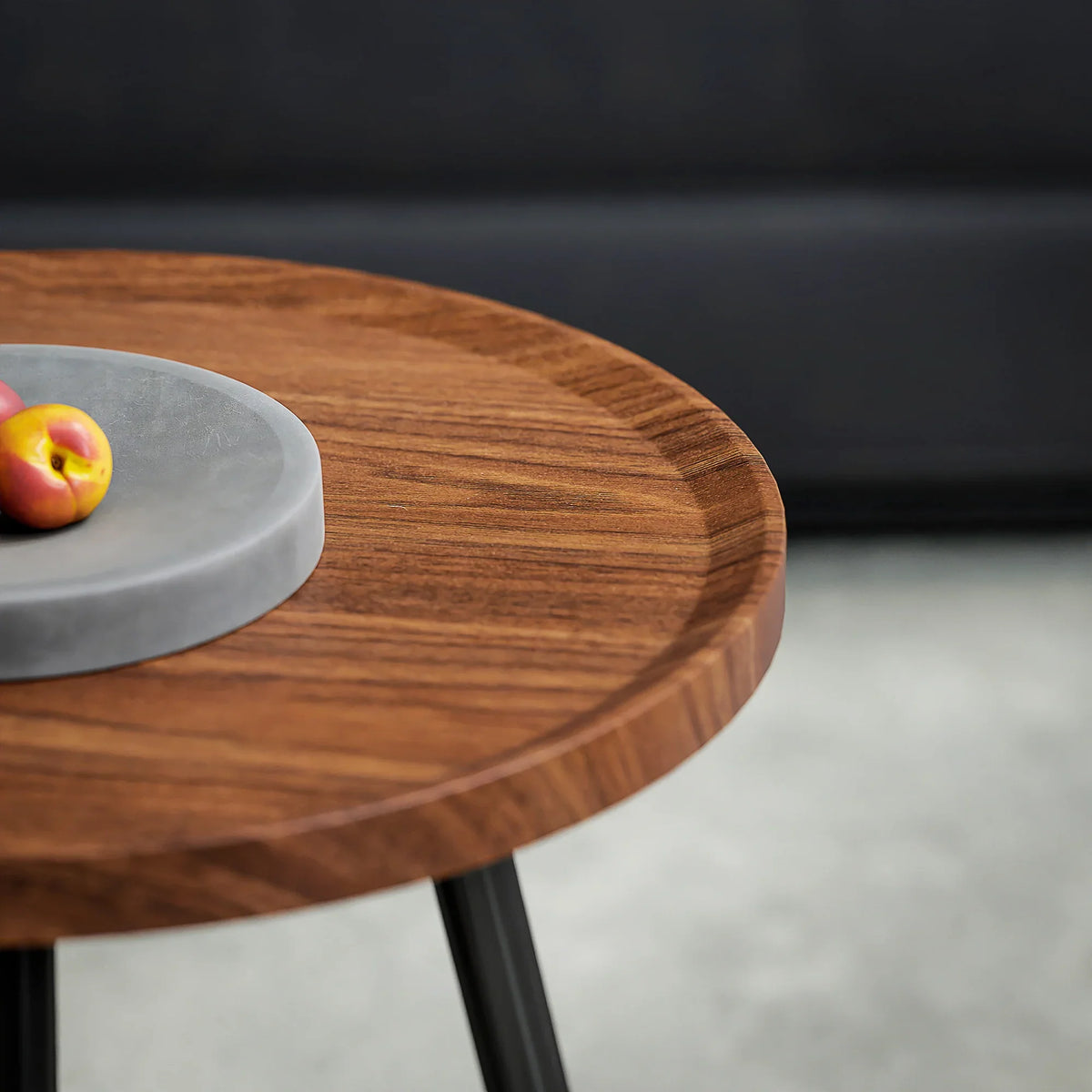 Close-up of round chestnut wood-effect tabletop on black metal legs
