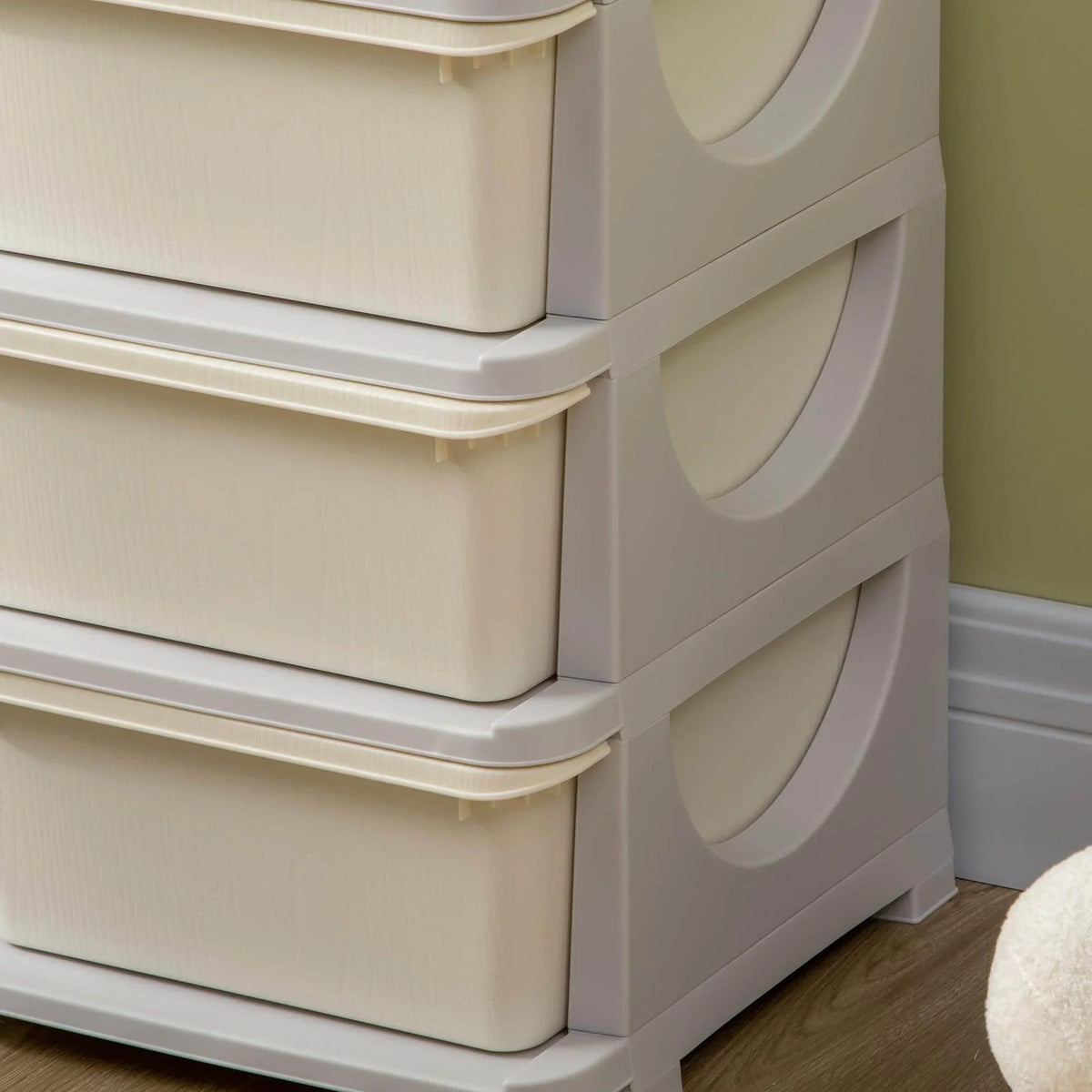 Side view of 3-tier kids toy storage tower with curved grip handles on drawer bins