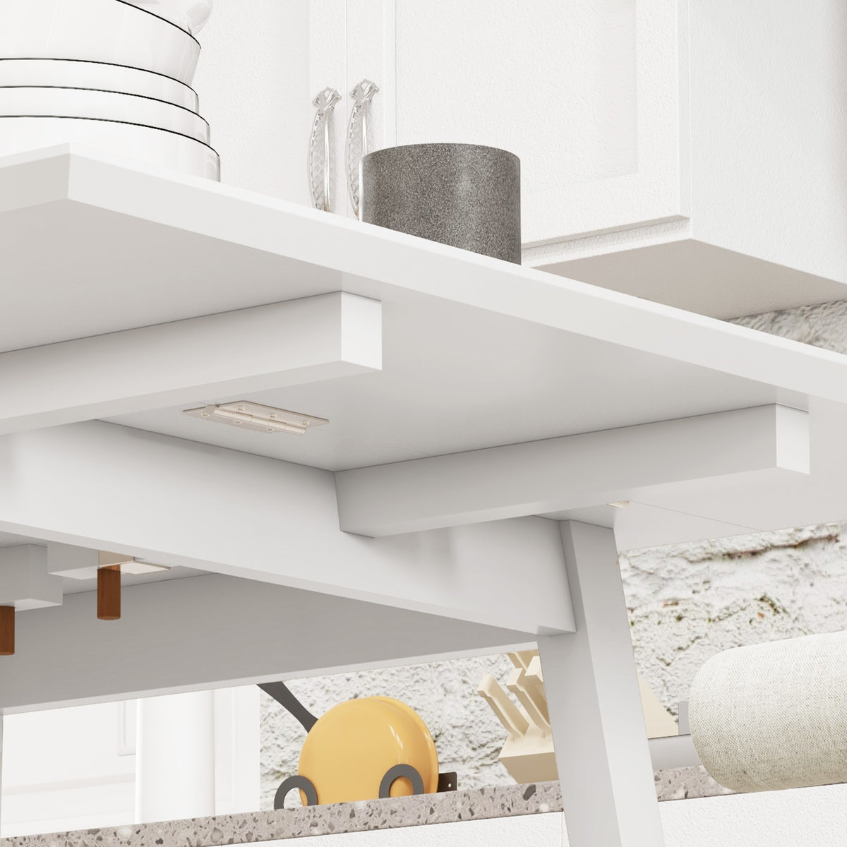 White dining table showing drop-leaf support brackets under the tabletop