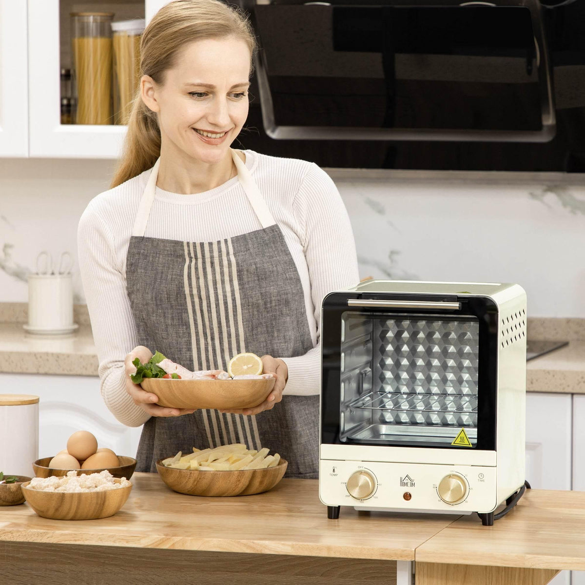 Cream white mini convection oven with open door on kitchen counter