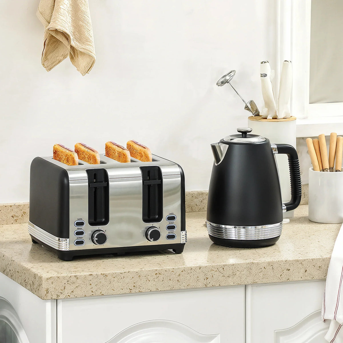 Black stainless steel 4-slice toaster and electric kettle set on countertop