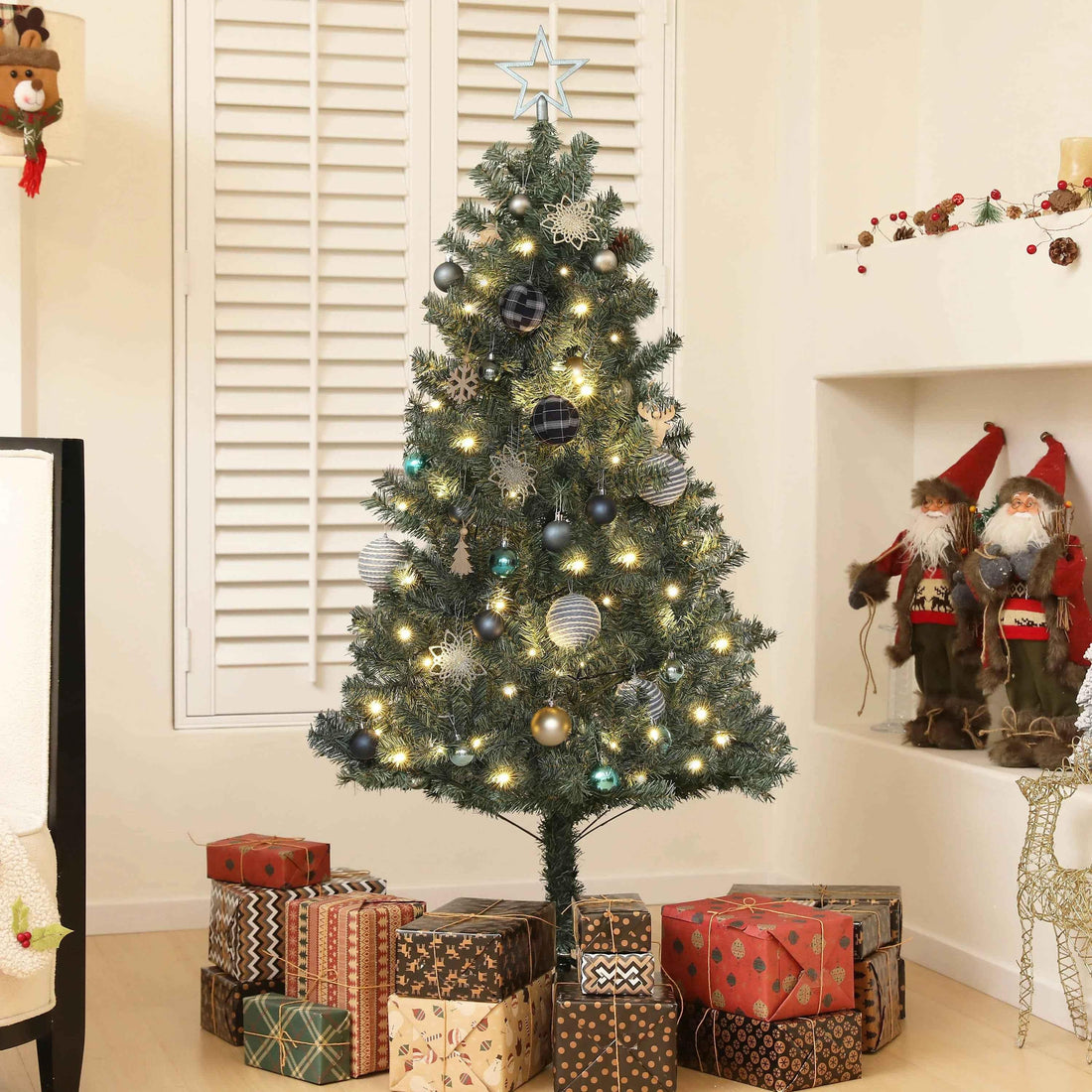 Decorated artificial Christmas tree with lights, ornaments, and gifts, perfect for home holiday decor.