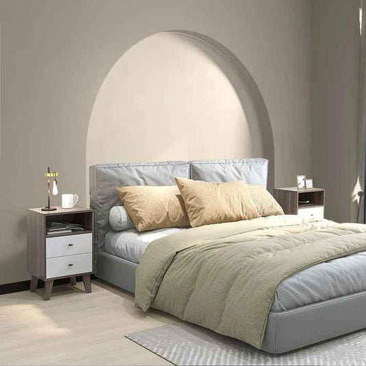 Modern gray upholstered bed with beige pillows, olive duvet, and matching nightstands in minimalist bedroom