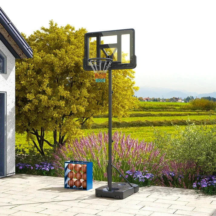 Adjustable outdoor basketball hoop with portable base on patio, perfect for home garden play