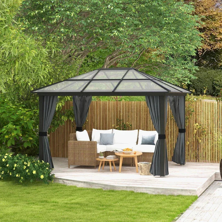 Black outdoor gazebo with curtains, wicker sofa, and glass roof on wooden deck in garden