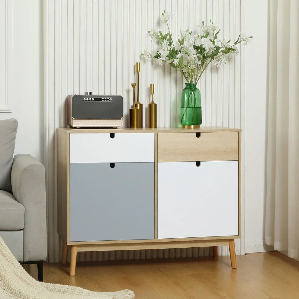 Modern sideboard with white and gray doors, wooden legs, styled with vase and decor in living room