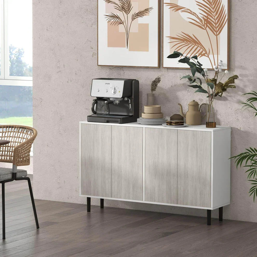 Modern white kitchen sideboard cabinet with four doors and pine wood legs in living room, decorated with coffee machine, dishes, and plants, from ALL4U RETAILER LTD.