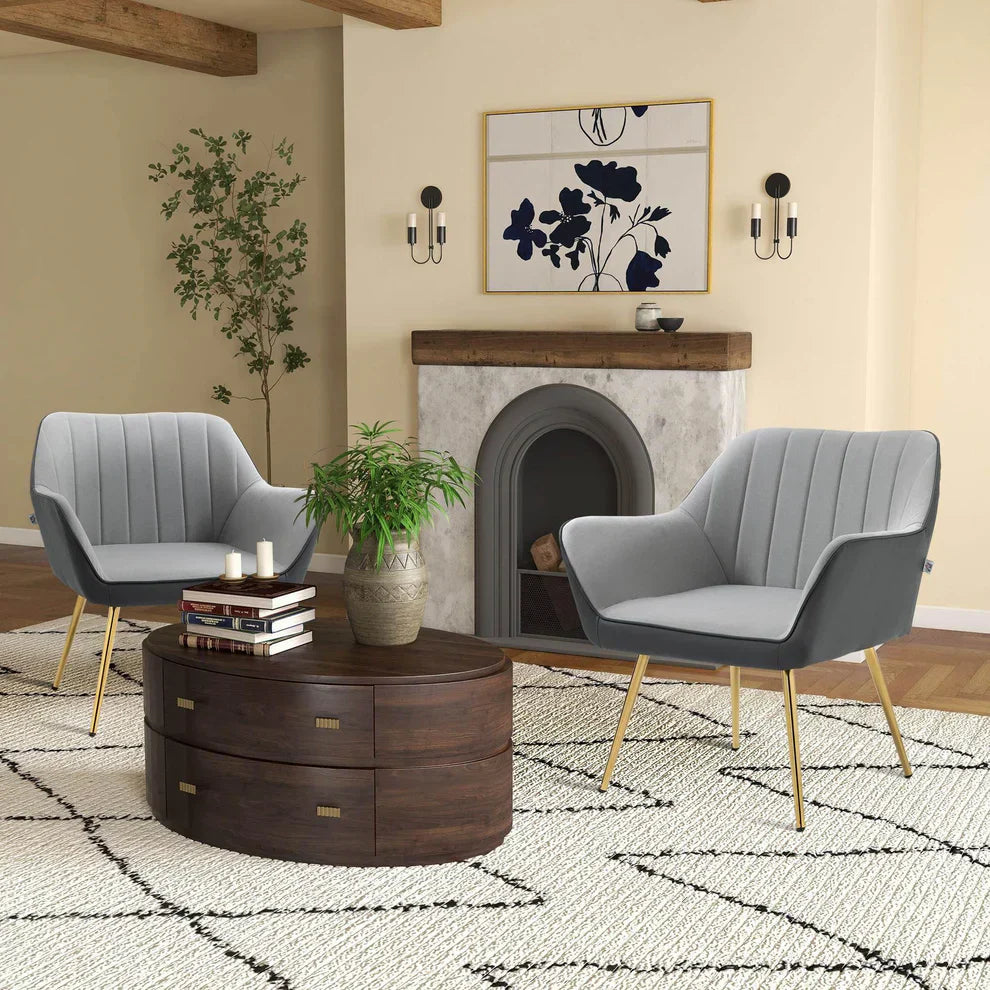 Modern living room with grey armchairs, wooden coffee table, and decorative fireplace