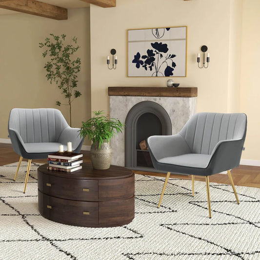Modern living room with grey armchairs, wooden coffee table, and decorative fireplace