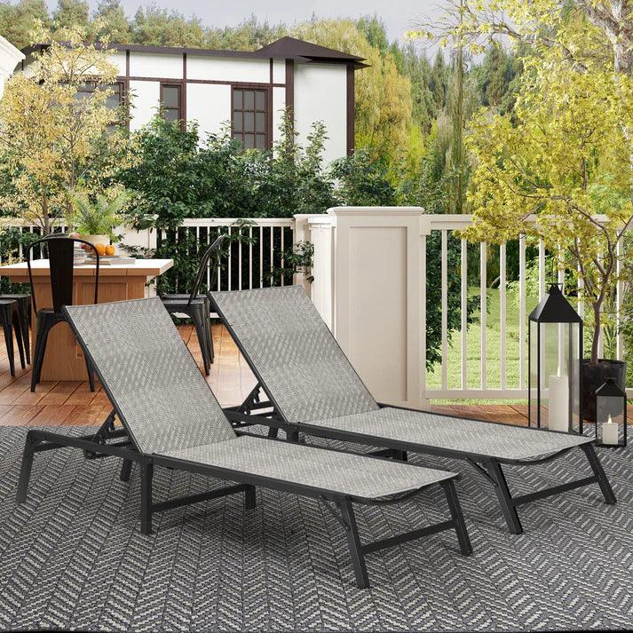 Two gray woven lounge chairs on outdoor patio rug, perfect for garden relaxation and backyard comfort.