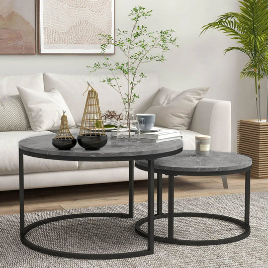 Modern living room with marble round nesting coffee tables, minimalist decor, and a cream sofa