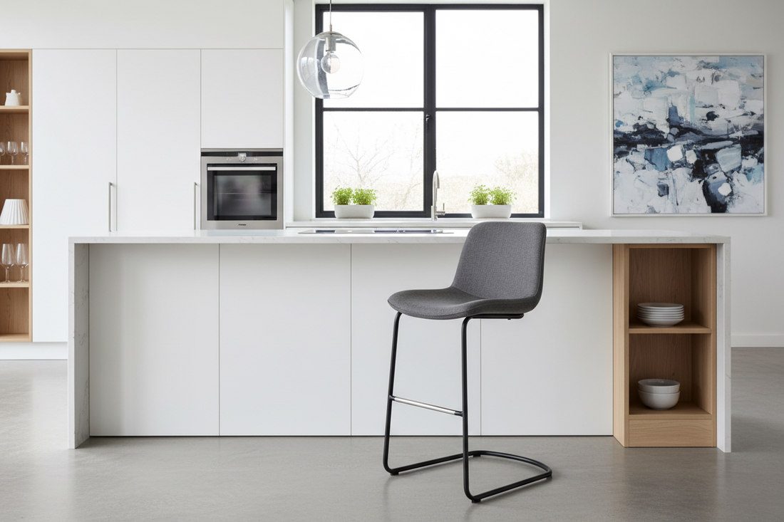 Modern grey bar stool with metal legs at a white kitchen island in a bright contemporary kitchen