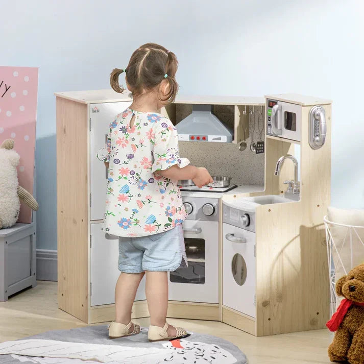 Child playing with wooden play kitchen set featuring stove, sink, and microwave for imaginative home play