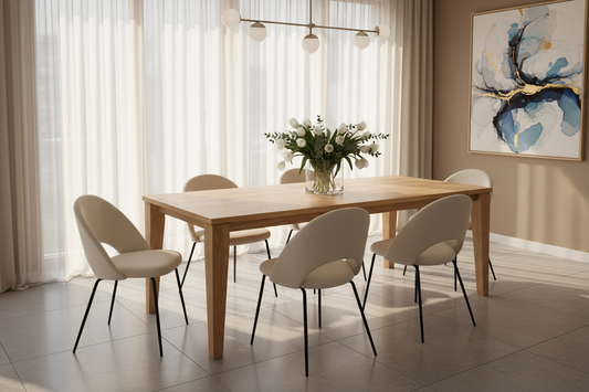 Modern wooden dining table with six beige chairs, floral centerpiece, and abstract wall art