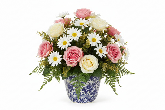 Artificial flower arrangement with pink roses and white daisies in a blue patterned pot