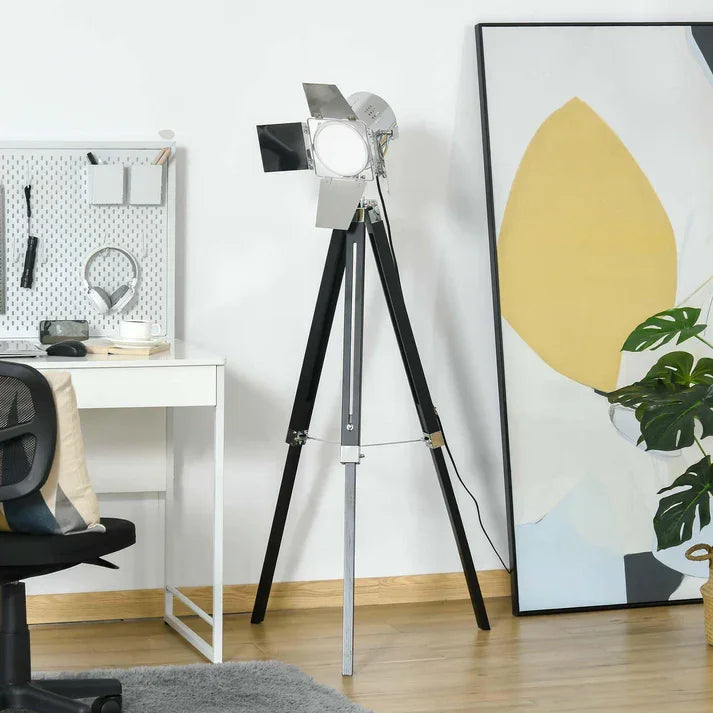Modern tripod floor lamp with adjustable spotlight in home office setting