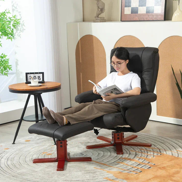 Black leather recliner chair with footrest, perfect for reading in cozy living room