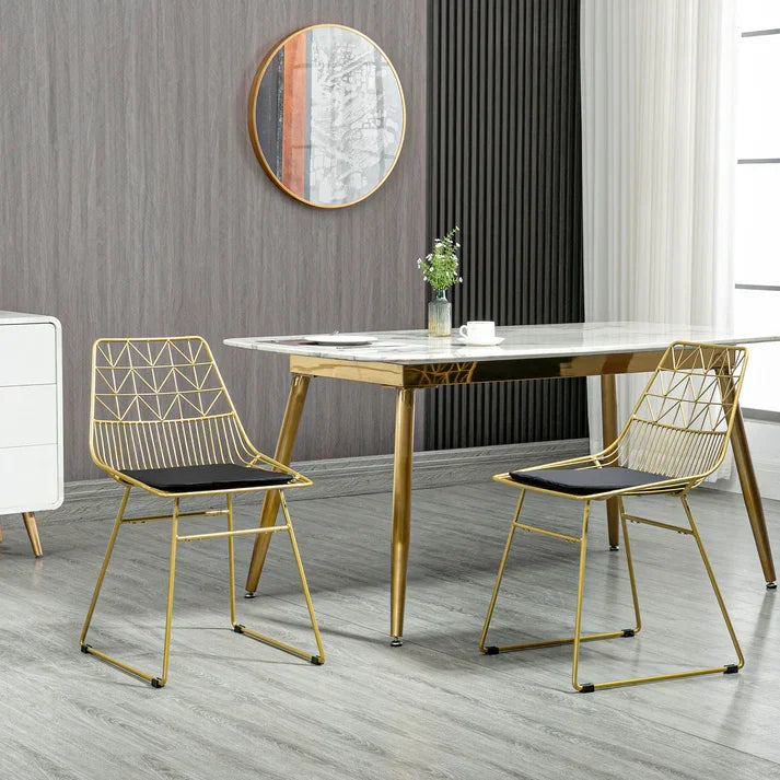 Modern gold dining table with geometric wire chairs, marble top, stylish home decor
