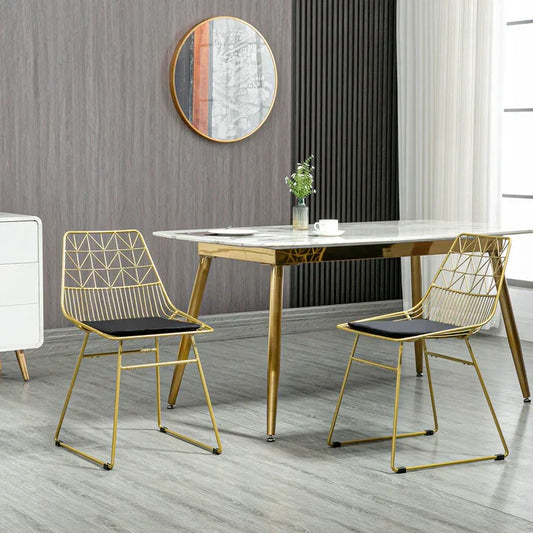 Modern gold dining table with geometric wire chairs, marble top, stylish home decor