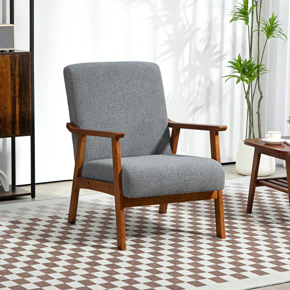 Gray textured armchair with wooden frame on checkered rug, modern home decor