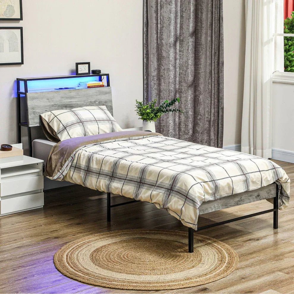 Modern single bed with LED headboard, plaid bedding, and round jute rug in cozy bedroom