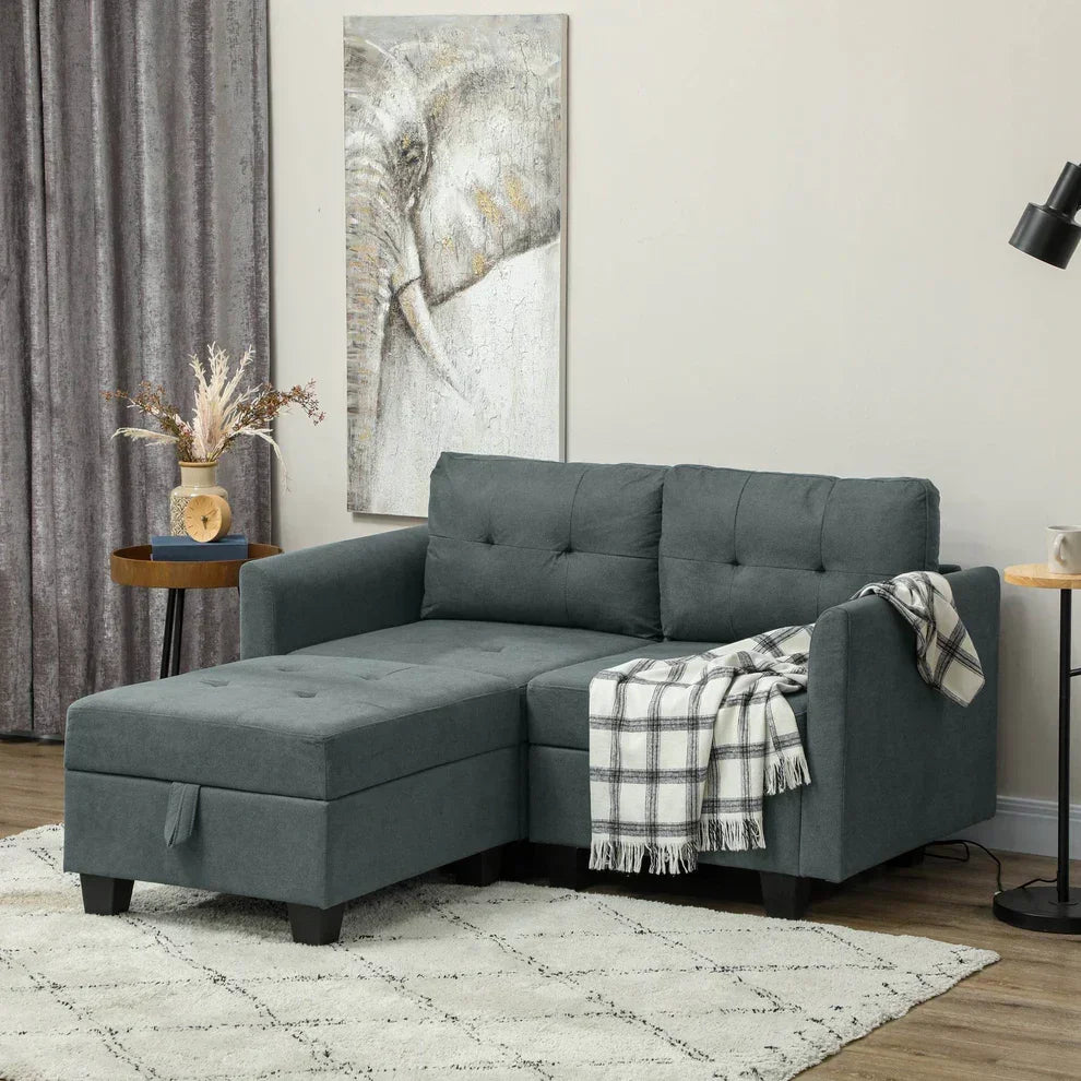 Gray tufted sectional sofa with chaise, cozy plaid blanket, modern living room decor
