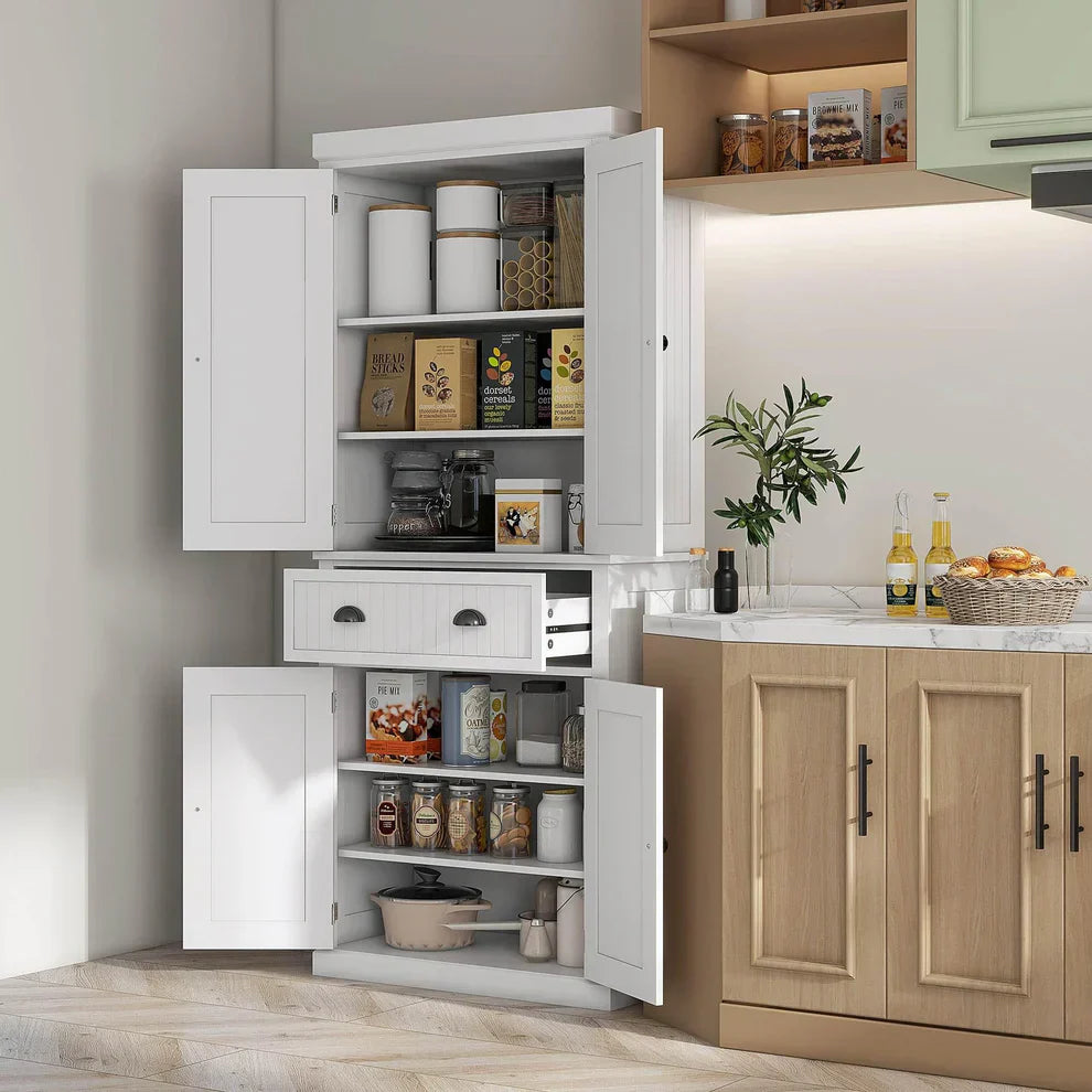 White kitchen storage cabinet with open doors displaying organized pantry items, next to countertop