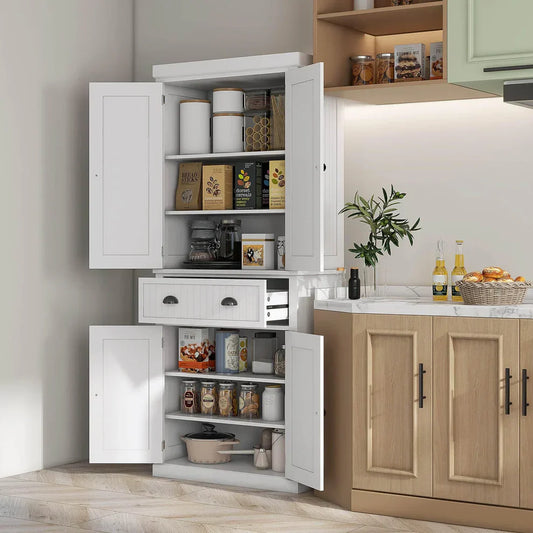 White kitchen storage cabinet with open doors displaying organized pantry items, next to countertop
