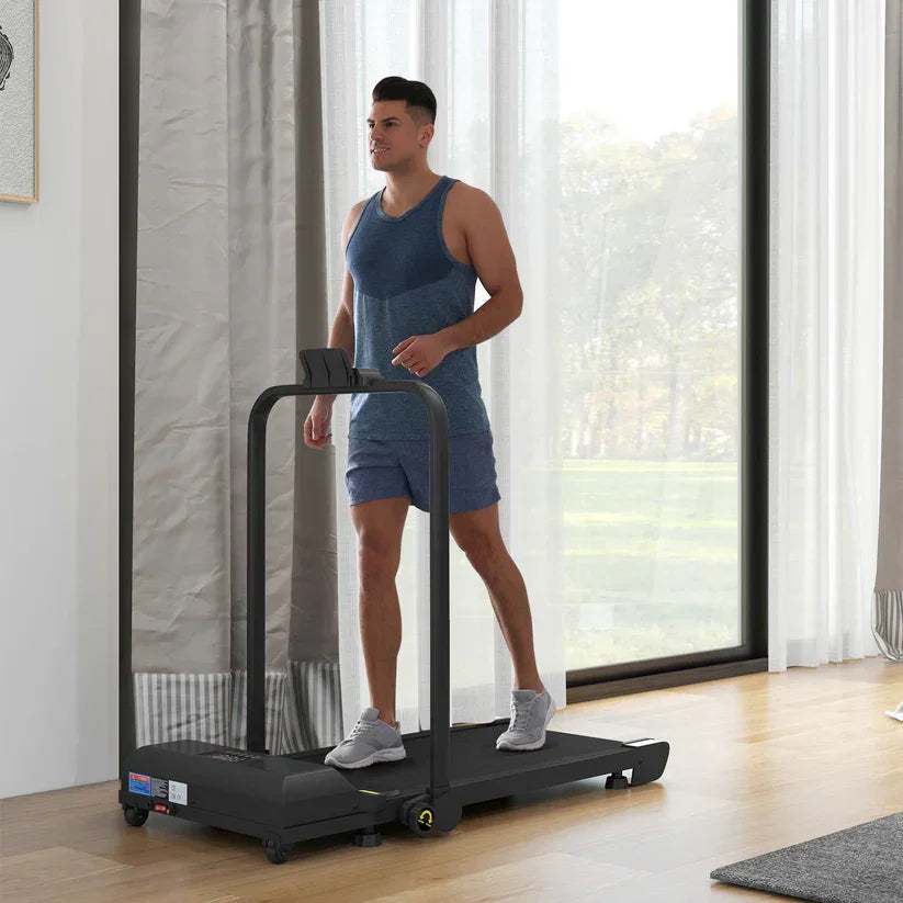 Man using compact home treadmill in bright living room for indoor fitness workouts