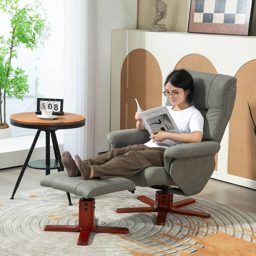 Woman relaxing in a grey recliner chair with footrest, reading in a modern living room setting