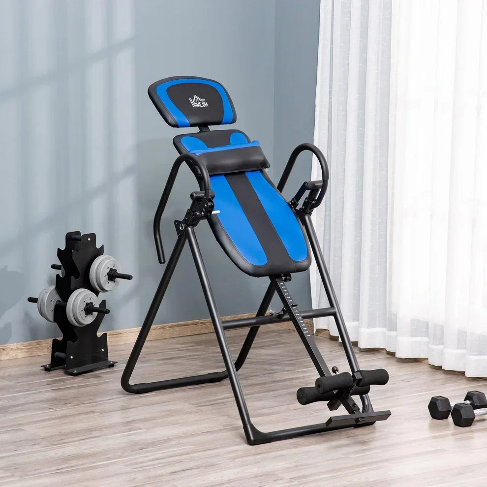 Blue and black inversion table for home gym workouts with dumbbells nearby