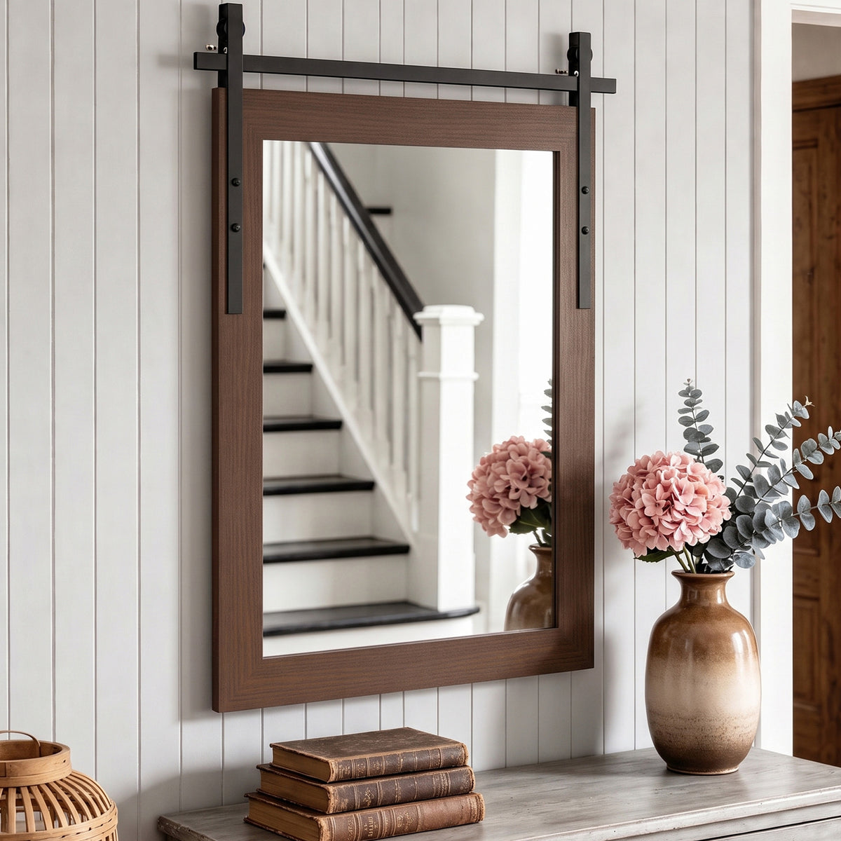 Rectangular wall mirror with dark brown wood frame and black hanging bar hardware