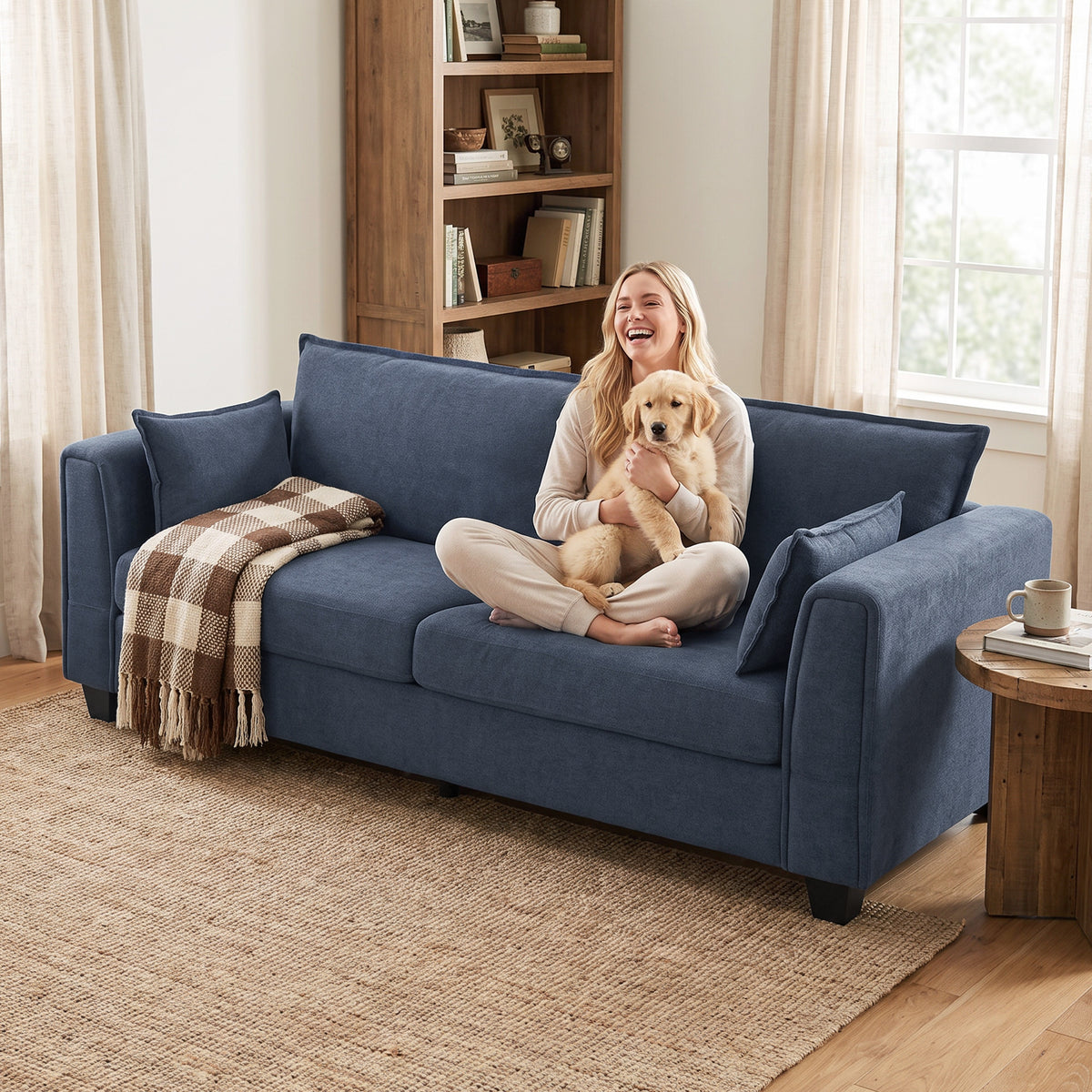 3-seat sofa in dark blue fabric with two throw pillows and cushioned seat