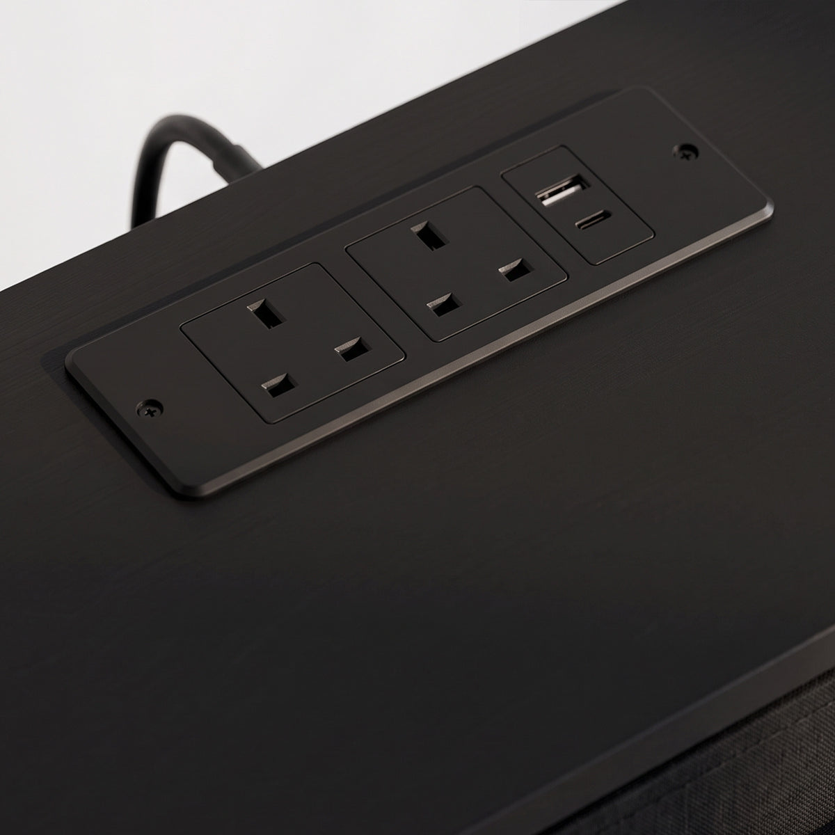 Black built-in power panel with multiple ports on the TV stand top