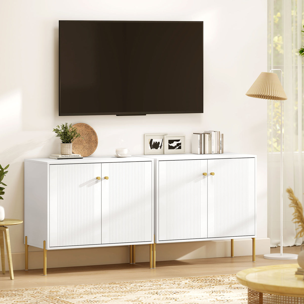 White sideboard cabinet with two fluted doors, gold legs, and knob pulls