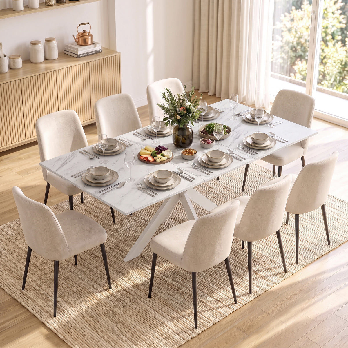 Extendable dining table with white marble-look top and six cream upholstered chairs