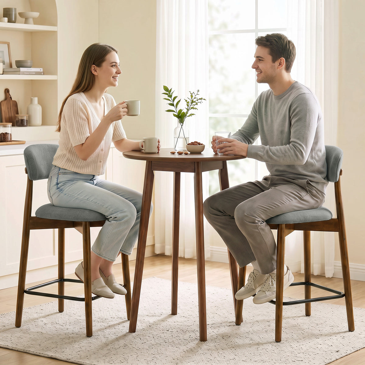 Set of 2 grey upholstered bar stools with curved backrest and black footrest rings