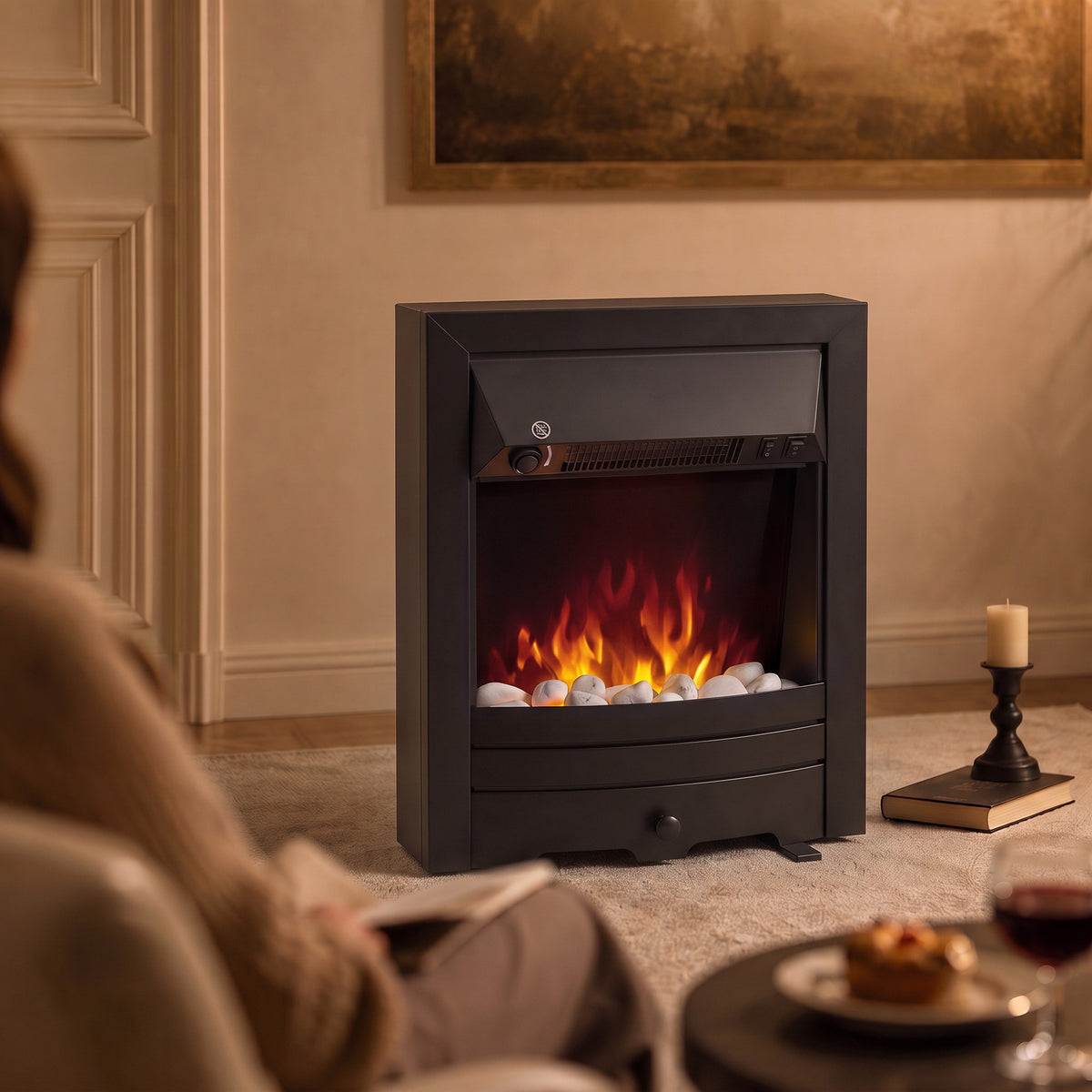 Black electric fireplace stove with inset window and LED flame effect, decorative pebble bed