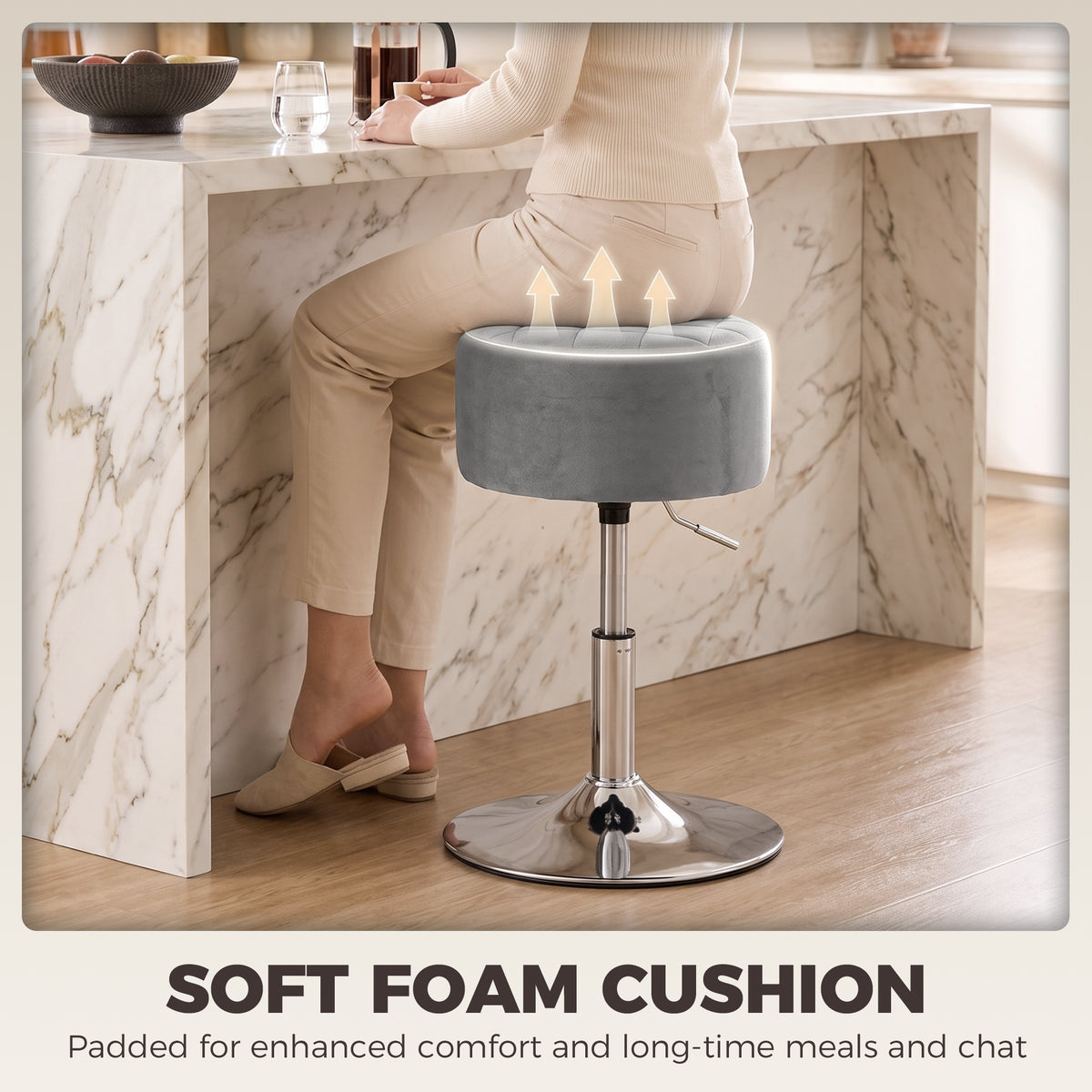 Grey swivel bar stool with padded round seat and chrome pedestal base