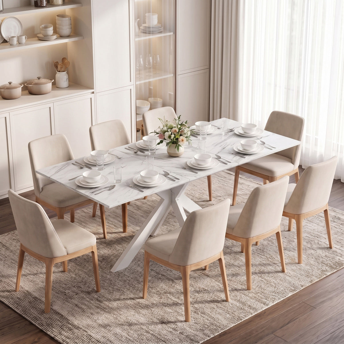 Extendable dining table with white marble-look top and eight cream upholstered chairs