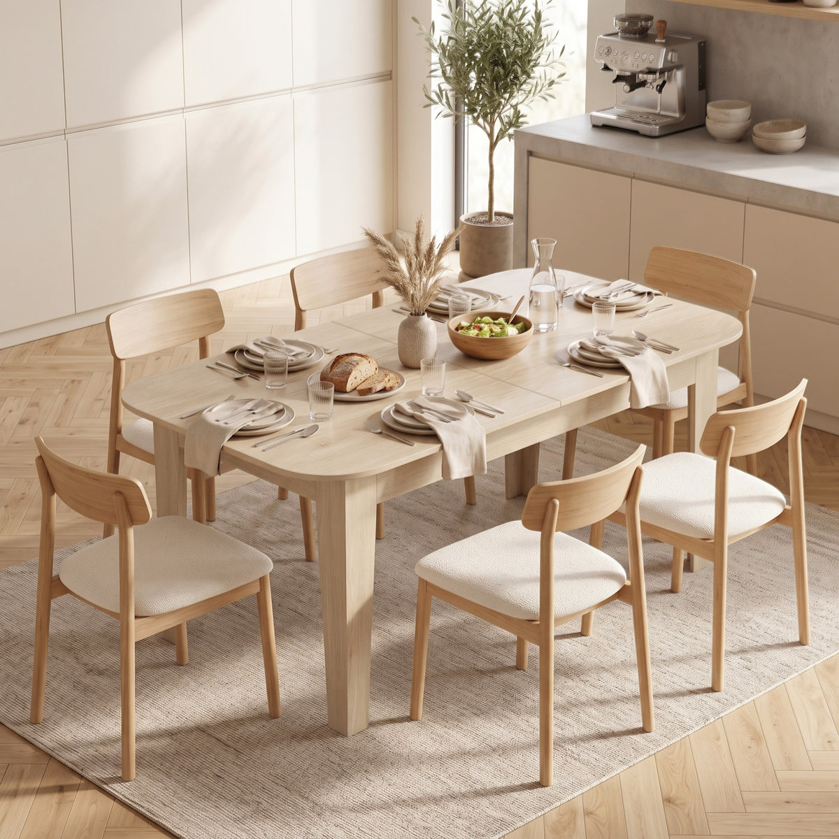 Light oak extendable oval dining table with four chairs and table centerpiece