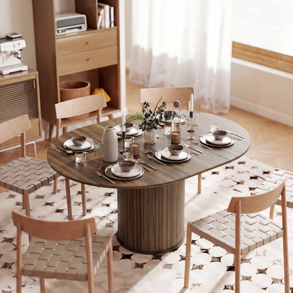 Round extendable dining table with dark wood pedestal base, styled with a table setting