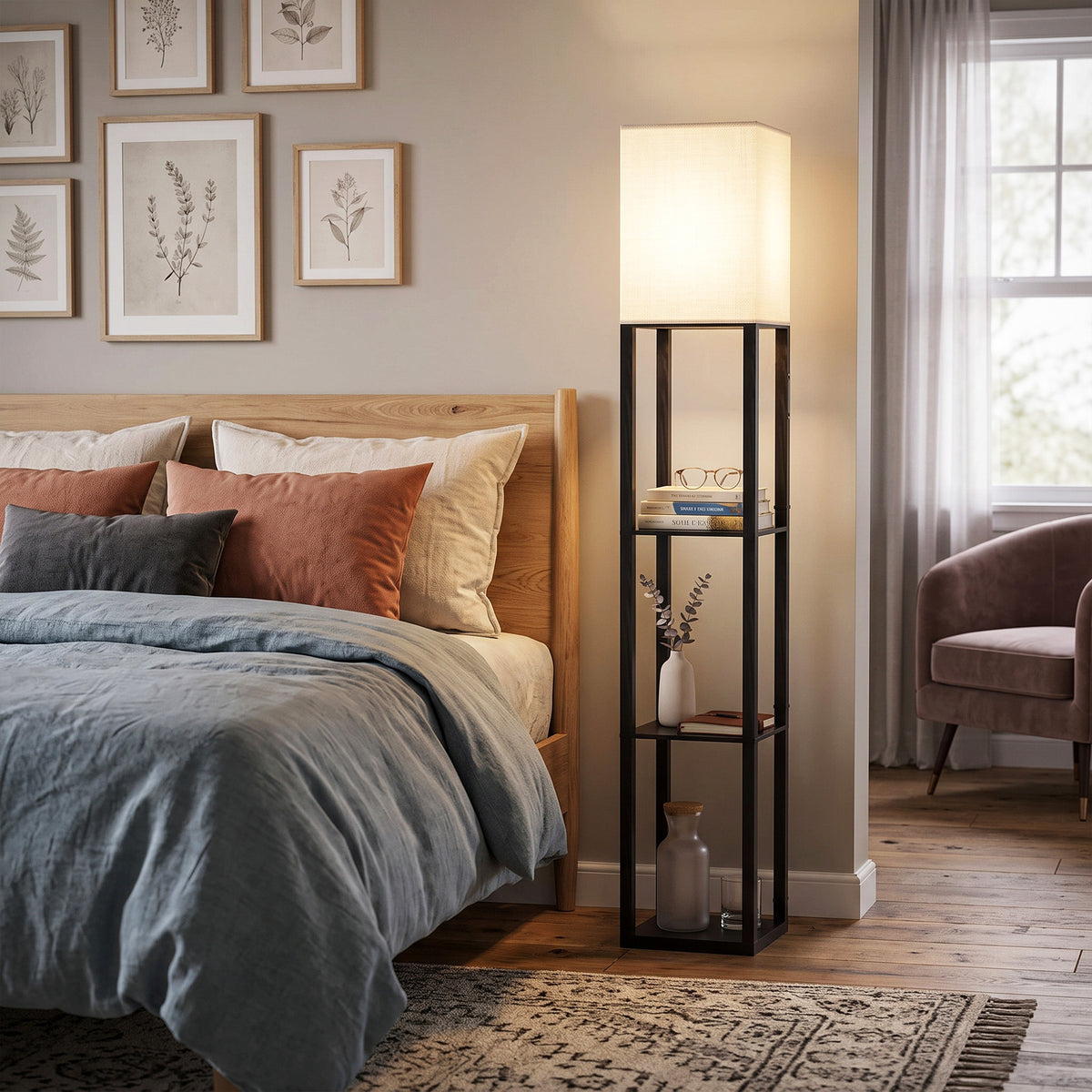 Black floor lamp with glass shelves and fabric shade, warm light by bed